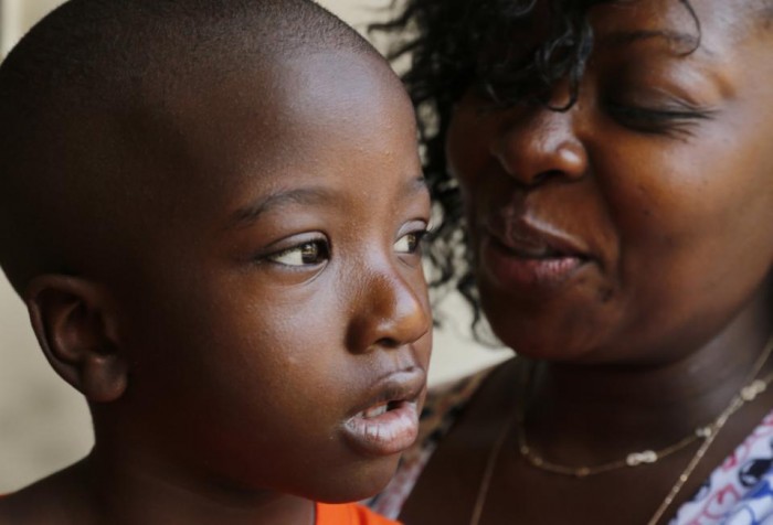  In this July 23, 2015 photo, Stacy Rutledge smiles at her 4-year-old son, Donovan Burden, at Marillac St. Vincent de Paul Center, a day care center in Chicago. Rutledge is one of a growing number of people feeling the pinch of the state's budget impasse as social service agencies don't get promised payments, programs are reduced or eliminated and some agencies close their doors while Republican Gov. Bruce Rauner and Democrats who run the Legislature battle over economic policies and the influence of labor. (AP Photo/Christian K. Lee)