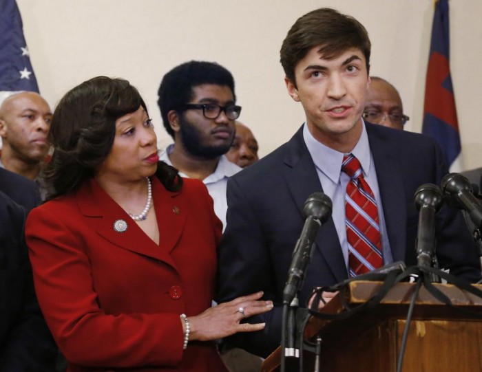 In this March 25, 2015 file photo, Oklahoma state Sen. Anastasia Pittman, left, D-Oklahoma City, stands with Levi Pettit, right, a former University of Oklahoma fraternity member caught on video leading a racist chant, during a news conference at Fairview Baptist Church in Oklahoma City. Pettit apologized for the chant. Sigma Alpha Epsilon, the fraternity connected to the racist video, has announced the hiring of a diversity director who will be charged with helping the fraternity’s chapters across the nation become more inclusive. (AP Photo/Sue Ogrocki, File)