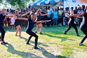 Young dancers wait to perform their hip-hop number for fans and supporters at the 49th annual Watts Summer Festival stage at Ted Watkins Park. 