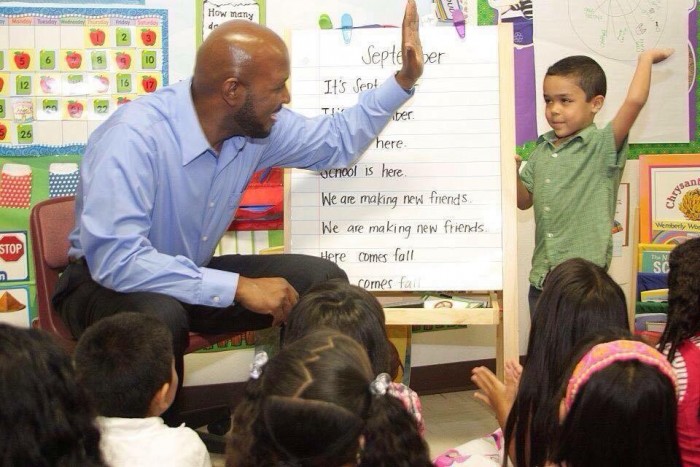 Compton Unified Board President Micah Ali high fives student from Today’s Fresh Start, which was recently approved for charter school status (courtesy photo)   