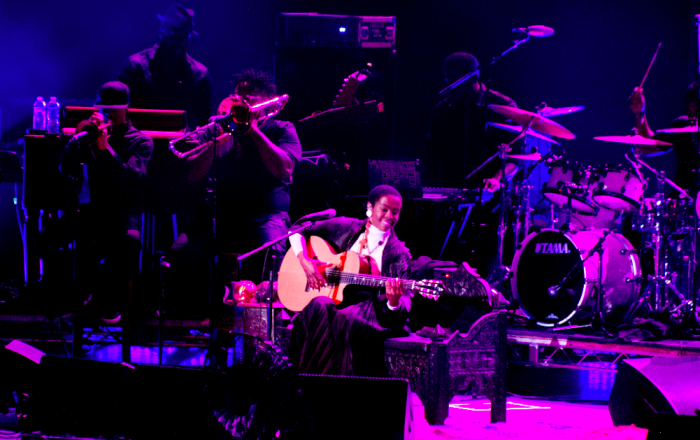 Lauren Hill sat and played acoustic guitar along with her band at the Greek Theater. (Troy Tieuel/LA Sentinel)