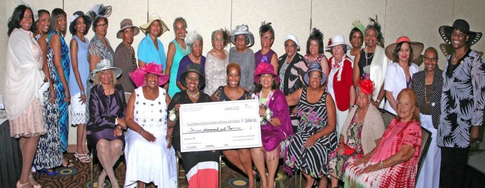 The members of the Ellen Marie Jackson Ladies of Grace Chapter #13 of the Knights of Peter Claver present a donation from their High Tea fundraiser to Francine Martin of the Good Shepherd Shelter for Battered Women/Children.