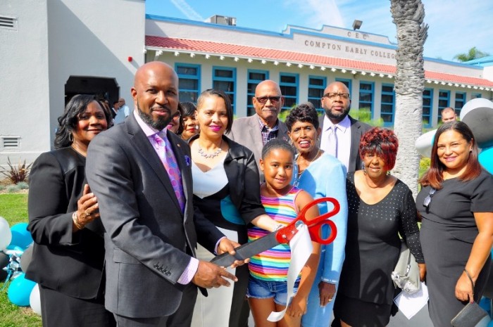 CUSD Board of Trustees President Micah Ali and Vice-President Satra Zurita (holding scissors together) officially welcome the community into Compton Early College, Saturday, October 24, during a ribbon-cutting ceremony in celebration of the school's recent opening. They are joined by Principal Mattie Robertson (left), Board Members Charles Davis (back row, center), Margie Garrett (second row, third from the right), and Mae Thomas (second from the right); as well as Keith Curry, Chief Executive Officer, El Camino College Compton Center (on Davis' right). Caption: Parent Lee Trimble (left) visited his son Reginald's (center) English Language Arts class where he met with instructor Mona Walker (right) and participated in an analytical writing exercise.