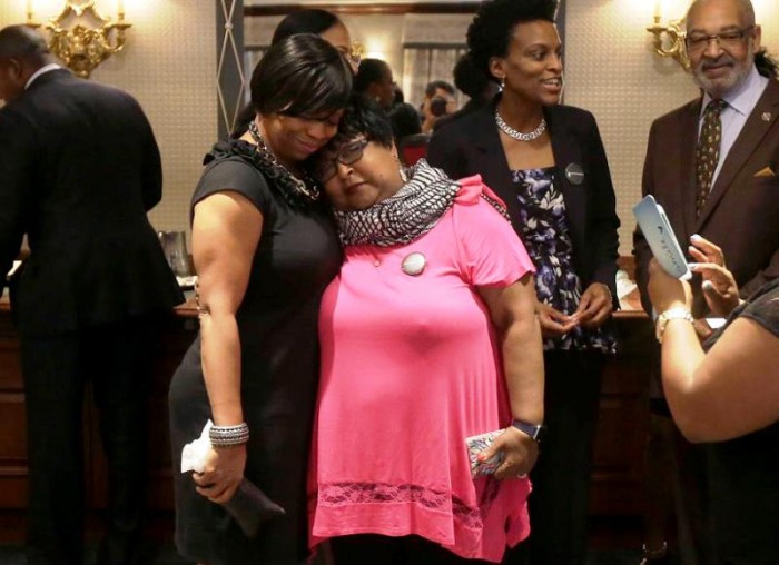 Plaintiffs Lisa Johnson, left, hugs Deborah Neal before a news conference announcing the filing a lawsuit over their ejection from a Napa Valley Wine Train, Thursday, Oct. 1, 2015, in San Francisco. A group of mostly black women who were ejected from a Northern California wine country train this summer say they felt humiliated and can't believe they were treated that way in 2015. (AP Photo/Jeff Chiu)