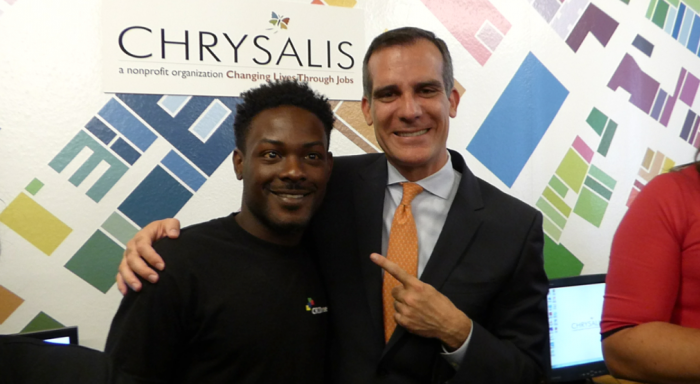 Mayor Eric Garcetti stands with Justin Sealie, 26, who reminded the launch audience why the program is important when he rose to tell his story. (courtesy photo)