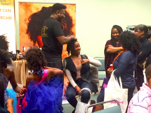 Lawrence Ray Parker II, the CEO and founder of Lawrence Ray Concepts, a natural organic line of hair products (pictured doing hair). Afrolicious Hair Expo brings together Black women of southern California. (Shannen Hill photo)