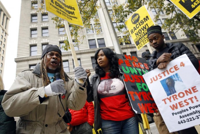 Protestors gather outside Clarence M. Mitchell Jr. Courthouse, Monday, Nov. 30, 2015, in Baltimore, after the arrival of William Porter, one of six Baltimore city police officers charged in connection to the death of Freddie Gray. Porter, whose trial jury selection began Monday, faces charges of manslaughter, assault, reckless endangerment and misconduct in office. (AP Photo/Patrick Semansky)