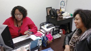 The Certified Enrollment Counselor Sylvia Jackson (left) helps client Sheyla Magaden enroll for health insurance under the Affordable Care Act at the offices of the Riverside County Black Chamber of Commerce.