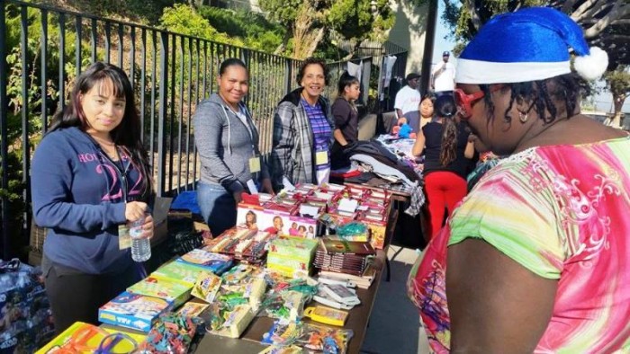 Before the clouds blew in and the rain poured, people lined up in droves, empty handed, but left with an abundance of holiday goodies on Saturday December 19, 2015 dubbed Humanitarian Day at Jesse Owens Park in Los Angeles (courtesy photo)