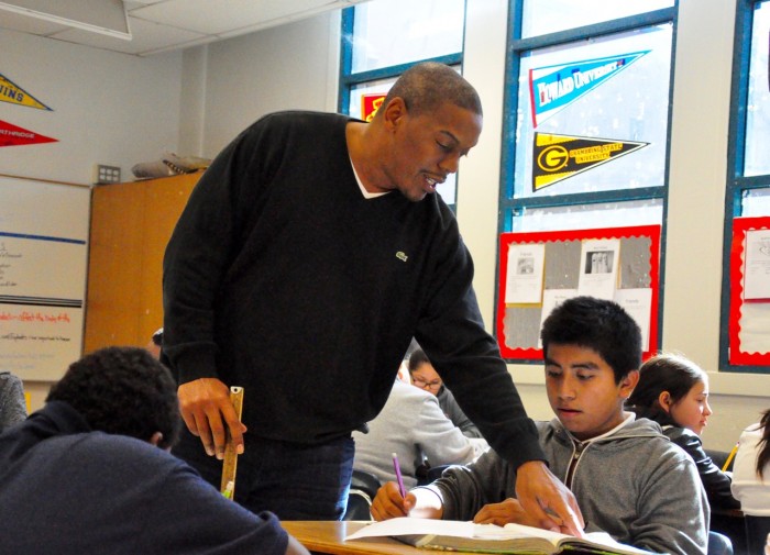 Willowbrook Middle School's Regis Inge guides sixth-grader Jimmy Cadenas with his social studies assignment. (courtesy photo)