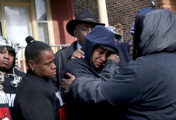 Janet Cooksey, center, the mother of Quintonio LeGrier, is comforted by family and friends during a news conference to speak out about Saturday's shooting death of her son by the Chicago police, on Sunday, Dec. 27, 2015, in Chicago. Grieving relatives and friends of two people shot and killed by Chicago police said Sunday that the city's law enforcement officers had failed its residents. (Nancy Stone/Chicago Tribune via AP) 