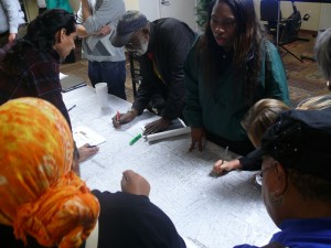 Community members pick spots for trees on a map of the Crenshaw District. Photo by Brian W. Carter