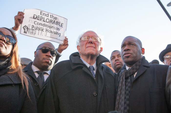 Sen. Bernie Sanders with Rev. Jamal Bryant (right) on a walking tour of the Sandtown-Winchester neighborhood in Baltimore. | Photo by Cheriss May, Howard University News Service.The CVS that was burned down during protests for Freddie Gray. Photo by Cheriss May, Howard University News Service.