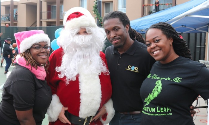 Rev. Charles Dorsey (2nd from right) and COR CDC staff pose with Santa.