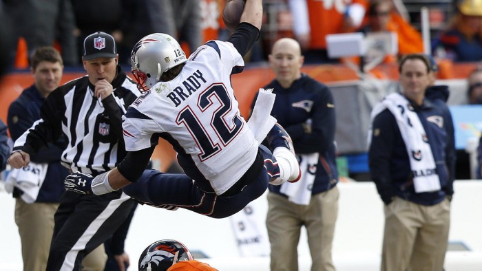 Broncos Aqib Talib tackles Patriots Tom Brady.  Photo:  David Zalubowski/AP