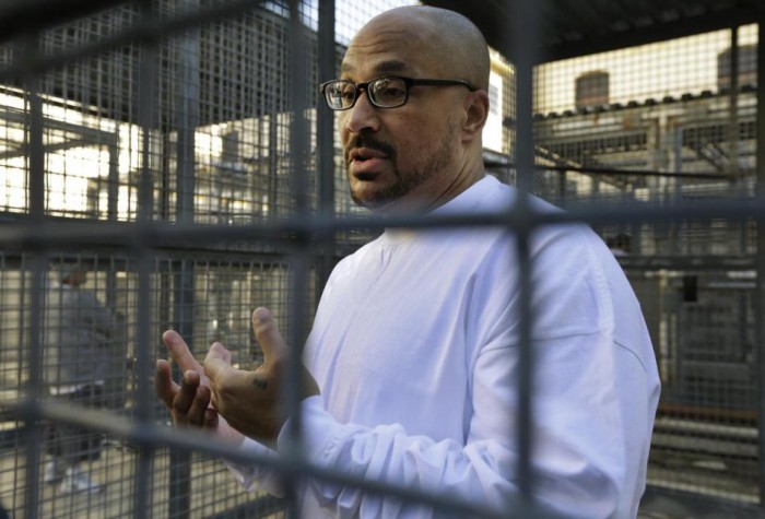  In this photo taken on Tuesday, Dec. 29, 2015, inmate Charles Crawford gestures while speaking to reporters in a recreation yard at San Quentin State Prison in San Quentin, Calif. With California's lethal injection protocol in limbo, the nearly 750 inmates at San Quentin State Prison, the nation’s most populous death row, are more likely to die from natural causes or suicide than execution. The inmates await a final decision on a proposed one-drug execution method and the possibility that voters in 2016 will scrap the death penalty altogether. (AP Photo/Ben Margot)