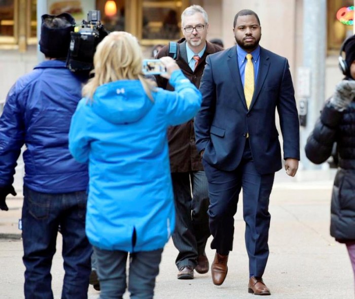 Officer William Porter, right, arrives at Courthouse East with his attorneys Wednesday, Jan. 6, 2016, in Baltimore. Circuit Judge Barry Williams is holding a motions hearing Wednesday ahead of the trial for Caesar Goodson, who drove the police transport van where Freddie Gray was critically injured. Prosecutors want Porter, whose trial ended in a mistrial last month, to testify against Goodson and Sgt. Alicia White. (Jerry Jackson/The Baltimore Sun via AP)