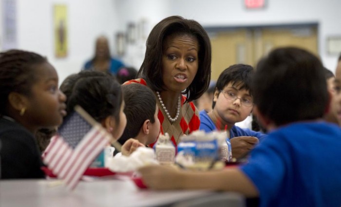 In this Jan. 25, 2012 file photo, First lady Michelle Obama has lunch with school children at Parklawn elementary school in Alexandria, Va. A bipartisan Senate bill released Monday would revise healthier meal standards put into place over the last few years to give schools more flexibility in what they serve the nation's schoolchildren, easing requirements on whole grains and delaying an upcoming deadline to cut sodium levels on the lunch line. (AP Photo/Pablo Martinez Monsivais)