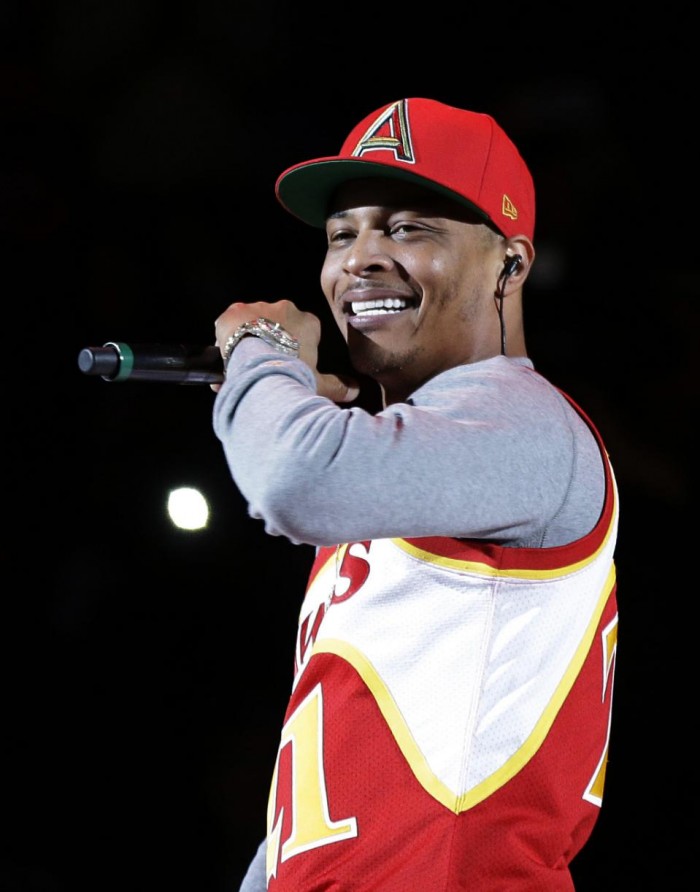  - FILE - In this Nov. 1, 2014, file photo, rapper T.I. performs before the start of an NBA basketball game between the Indiana Pacers and the Atlanta Hawks in Atlanta. The Hawks are collaborating with big-name hip-hop artists like T.I., Ludacris and Big Boi in what the team calls an effort to make amends after it was revealed two officials made racially charged remarks in separate incidents. (AP Photo/David Goldman, File)