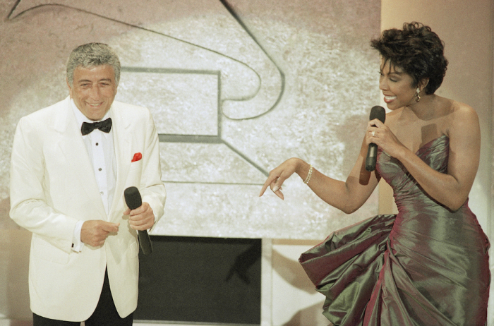 Singers Tony Bennett and Natalie Cole perform "Lady is a Tramp" during the 35th Grammy Awards Show, Feb. 24, 1993 in Los Angeles. Bennett and Cole presented a Grammy to Eric Clapton for the Album of the Year, while Bennett himself was given Grammy for Best Traditional Pop Vocal for "Perfectly Frank" during the pre-televised portion of the show. (AP Photo/Reed Saxon)