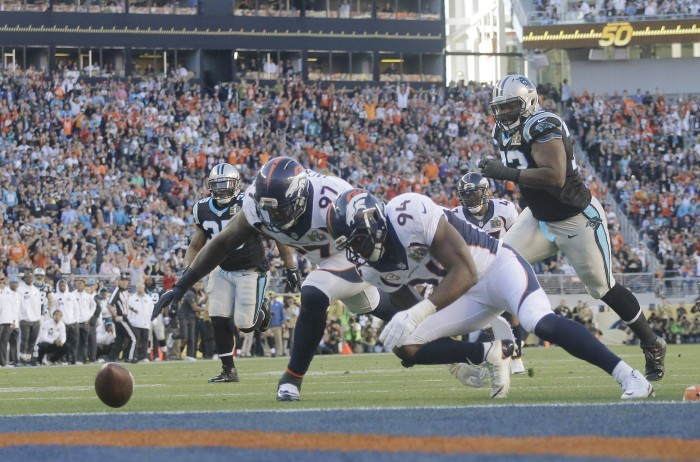 Broncos DeMarcus Ware (94) and Malik Jackson (97) Recover Panther Fumble.  Photo:  Associated Press