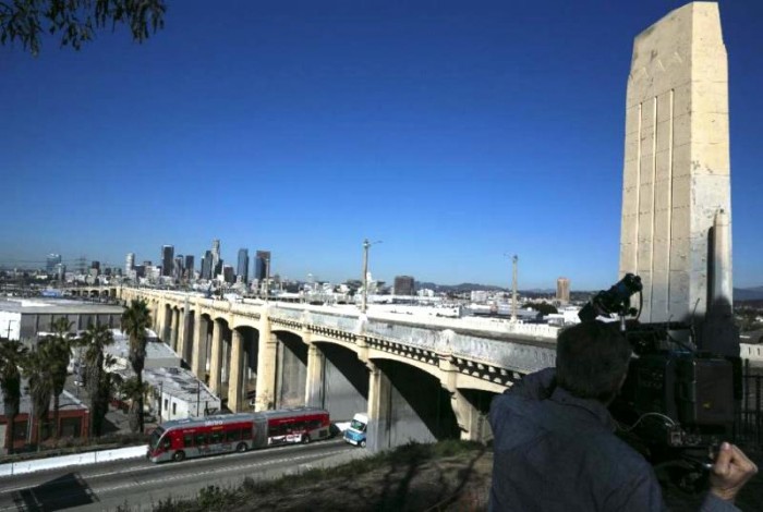 In this Wednesday, Feb. 3, 2016, photo The 6th Street Bridge that spans the Los Angeles River is seen in Los Angeles, before it is closed permanently for demolition. The landmark bridge, dating to the 1930's, is being replaced due to deterioration caused by a chemical reaction in the concrete. The $449 million project to build a replacement bridge, designed by architect Michael Maltzan, is expected to be completed by 2019 at the earliest. (AP Photo/Damian Dovarganes)