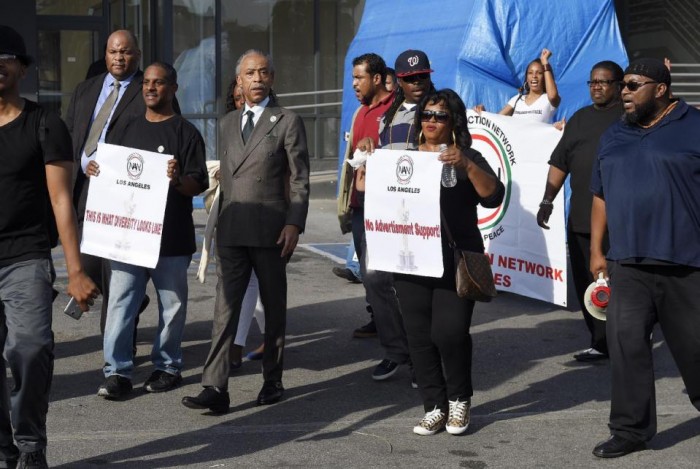 Rev. Al Sharpton, center, leads a rally prior to the Academy Awards ceremony, Sunday, Feb. 28, 2016, in the Hollywood section of Los Angeles in support of the nationwide TV tune-out protesting the lack of diversity in Hollywood. (AP Photo/Mark J. Terrill)