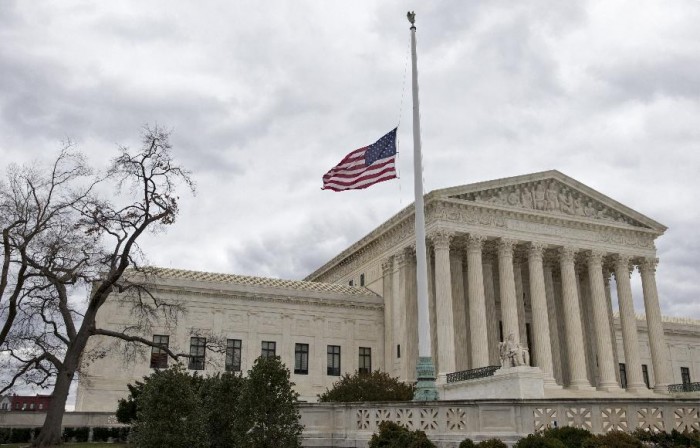 In this Feb. 25, 2016, file photo, in honor of Justice Antonin Scalia, a flag in the Supreme Court building's front plaza flies at half-staff in Washington. African-American voters see the Republican opposition to President Barack Obama filling the Supreme Court vacancy as the latest affront to the first black president. Obama isnt on the ballot this fall, but plenty of Republicans are. (AP Photo/J. Scott Applewhite, File)