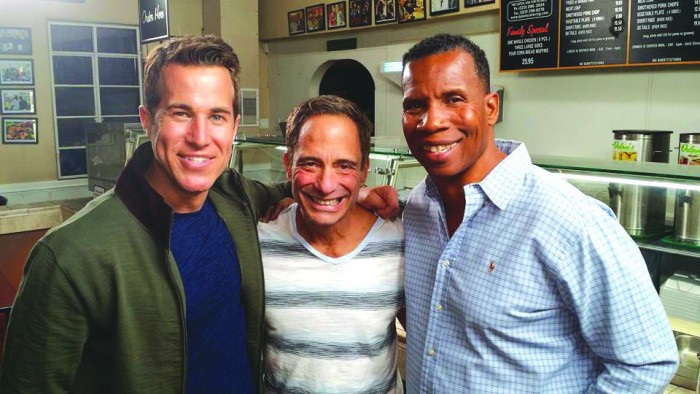 “South Of Wilshire” host Adam Glyn, show creator/executive producer Harvey Levin and Greg Dulan, owner of the soul food restaurant, Dulan’s.