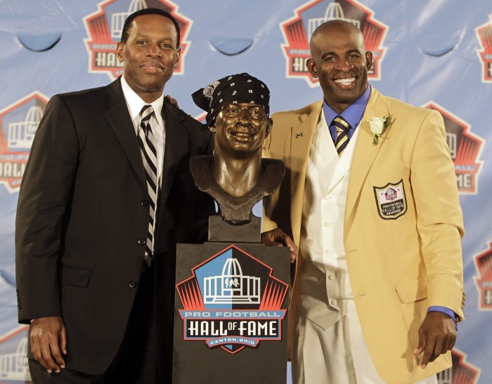 FILE - In this Aug. 6, 2011, file photo, Deion Sanders, right, poses with a bust of himself and his presenter, his agent Eugene Parker, during the induction ceremony at the Pro Football Hall of Fame in Canton, Ohio. Parker, the renowned football agent who represented such Hall of Famers as Emmitt Smith, Curtis Martin, Rod Woodson and Sanders, and who had cancer, died on Thursday, March 31, 2016, his family said in a statement. He was 60. (AP Photo/Tony Dejak, File)