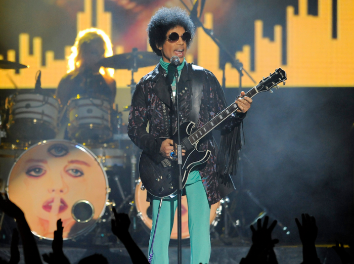 In this May 19, 2013 file photo, Prince performs at the Billboard Music Awards at the MGM Grand Garden Arena in Las Vegas. Prince, widely acclaimed as one of the most inventive and influential musicians of his era with hits including "Little Red Corvette," ''Let's Go Crazy" and "When Doves Cry," was found dead at his home on Thursday, April 21, 2016, in suburban Minneapolis, according to his publicist. He was 57. (Photo by Chris Pizzello/Invision/AP, File)