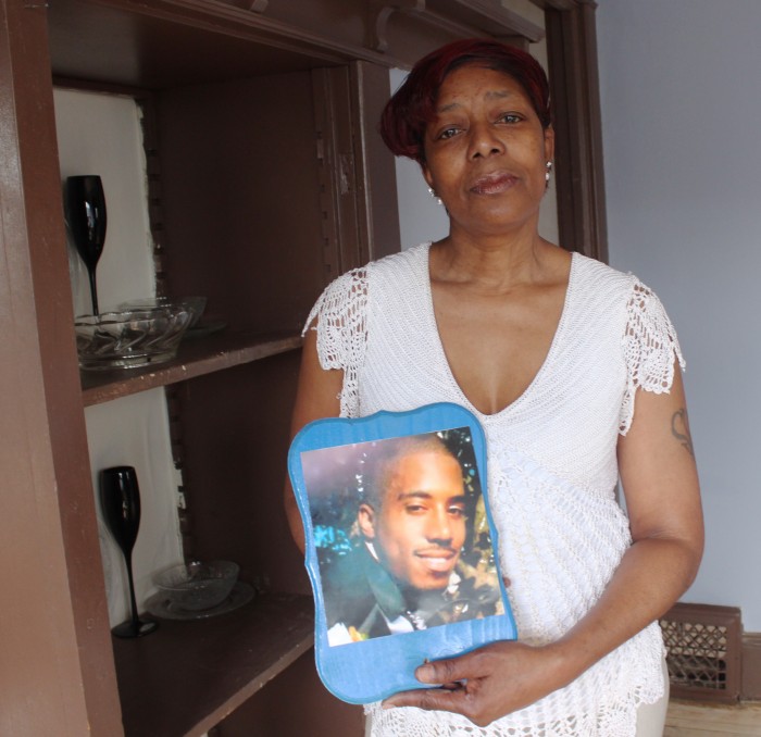 Maria Hamilton holds a photo of her son Dontre Hamilton, who was fatally shot by a Milwaukee police officer in April 2014, at her home on Monday, March 30, 2015 in Milwaukee. Maria has started a support group for mothers of sons killed in police encounters called Mothers for Justice United. The group is organizing a Mlilion Moms March in Washington, D.C. on Mother's Day for mothers in similar situations.  (AP Photo/Carrie Antlfinger)