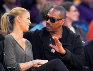  In this April 12, 2015, file photo, actor Eddie Murphy talks with his girlfriend Paige Butcher during an NBA basketball game between the Los Angeles Lakers and the Dallas Mavericks. (AP Photo/Mark J. Terrill, File)