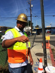 Joseph Mundine of LADWP’s Water System tests for water clarity during pipe flushing on 99th Street and Compton Blvd. (LADWP Photo)