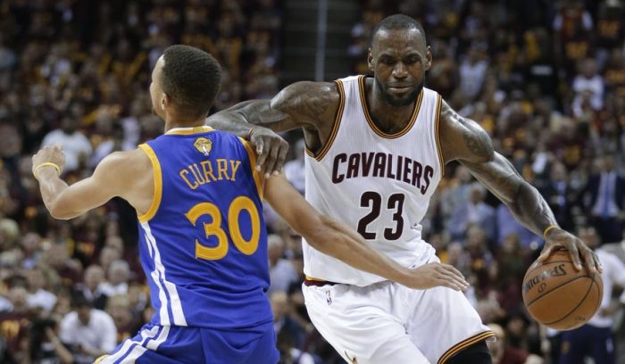 Cleveland Cavaliers forward LeBron James (23) tries to get around Golden State Warriors guard Stephen Curry (30) during the second half of Game 4 of basketball’s NBA Finals in Cleveland, Friday, June 10, 2016. (AP Photo/Tony Dejak)