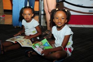  A couple of girls discover the wonder of books at the 2015 Leimert Park Village Book Fair. Photos Courtesy of Exum and Associates