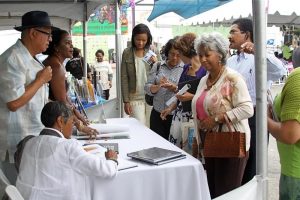 Chairpersons Dr. Bernard W. Kinsey and his lovely wife, Shirley, take time out to chat with the crowds and sign books at the Leimert Park Village Book Fair. Photos Courtesy of Exum and Associates