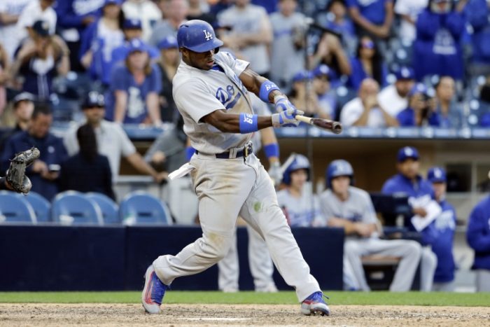 Los Angeles Dodgers' Yasiel Puig hits a two-run single during the seventeenth inning of a baseball game against the San Diego Padres, Sunday, May 22, 2016, in San Diego. (AP Photo/Gregory Bull)