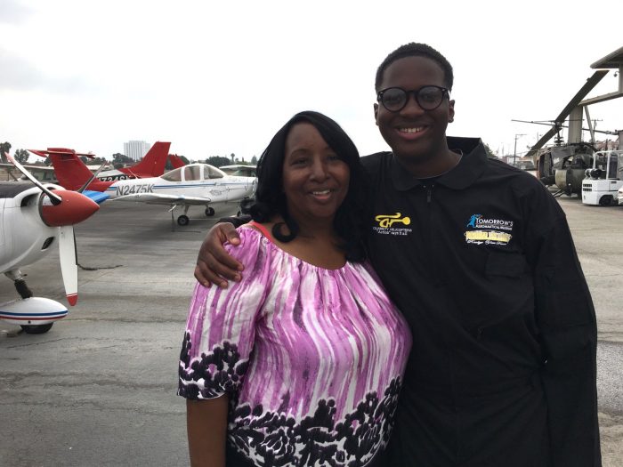 Isaiah says "bye for now" to his mother, Natalia Knox, before flying around the continental United States and into the record books as the youngest African-American pilot to do so.