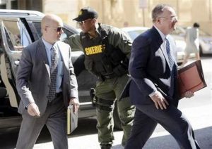 Lt. Brian Rice, left, one of the six members of the Baltimore Police Department charged in connection to the death of Freddie Gray, arrives with attorney Mike Davey, right, at a courthouse to hear a judge's ruling in his trial in Baltimore, Monday, July 18, 2016. Rice is the fourth of the six officers charged to go on trial in the 2015 death of Freddie Gray. (AP Photo/Steve Ruark)