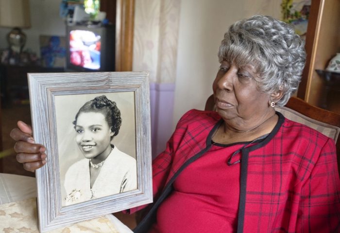 Flora Shanklin holds a portrait of her sister, the late Alberta Jones. Jones, Louisville's first female prosecutor, was murdered 51 years ago this week in 1965. The photo, a birthday present for their mother, was taken 10 years prior to her death. A Bellarmine professor who is writing a book about Jones, is asking Louisville police chief Steve Conrad to reopen the investigation into her unsolved death. (David Lutman /The Courier-Journal via AP)