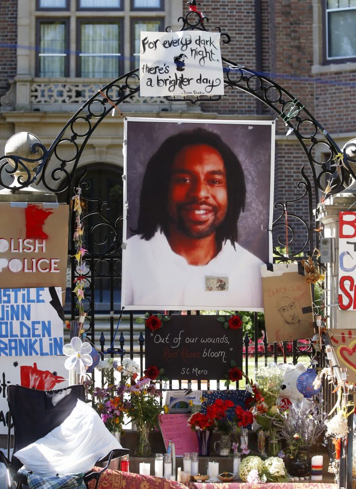 A memorial including a photo of Philando Castile adorns the gate to the governor's residence where protesters continue to demonstrate Monday, July 25, 2016, in St. Paul, Minn., against the July 6 shooting death of Castile by a St. Anthony police officer making a traffic stop in Falcon Heights, Minn. (AP Photo/Jim Mone)