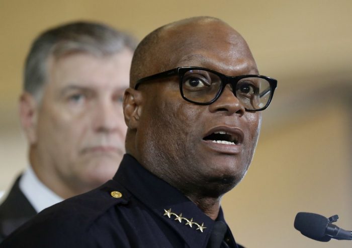 Dallas police chief David Brown, front, and Dallas mayor Mike Rawlings, rear, talk with the media during a news conference in Dallas. (AP Photo/Eric Gay) 