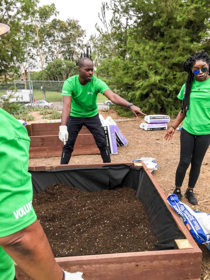  SCE volunteers help lay mulch and plant fruits and vegetables in garden boxes at La Tijera Academy of Excellence Charter School in Inglewood. (Photo by Glennetta Green)   