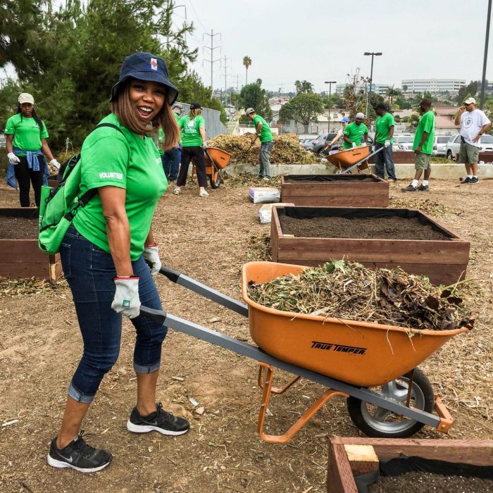 SCE volunteer Tammy Tumbling helps clear debris while building gardens at La Tijera Academy of Excellence Charter School in Inglewood.  (Photo by Glennetta Green) 