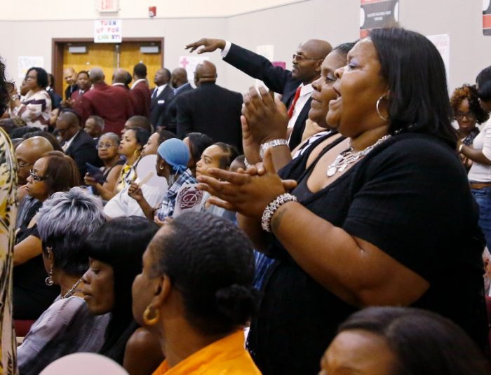 Ayeahel Ores, of Tulsa, sings during the funeral service for Terence Crutcher in Tulsa, Okla., Saturday, Sept. 24, 2016. Crutcher was fatally shot Sept. 16 by Officer Betty Jo Shelby. (AP Photo/Sue Ogrocki)