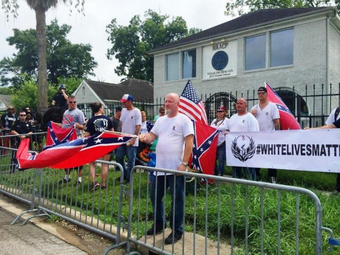  People with a White Lives Matter sign demonstrate in front of the NAACP office in Houston. (DARLA GUILLEN/AP)