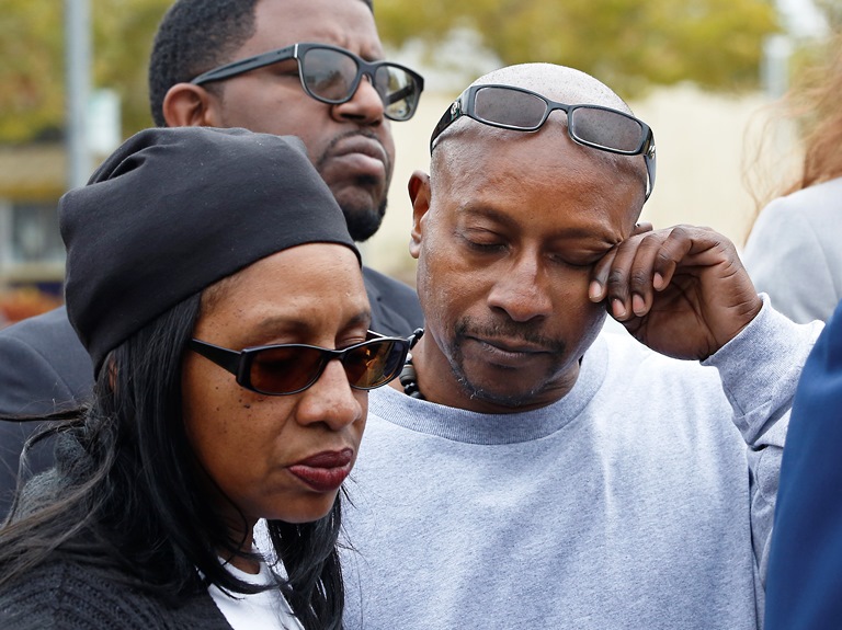 Family of black man shot 14 times by police wants charges