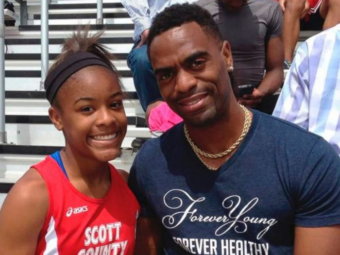 Trinity Gay poses for a photo with her father Tyson Gay.(Mark Maloney/Lexington Herald-Leader via AP)