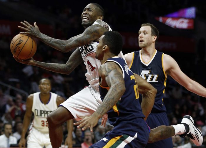 Los Angeles Clippers guard Jamal Crawford, left, drives to shoot against Utah Jazz forward Joel Bolomboy, center, of Russia, and forward Joe Ingles, of Australia, trailing during the second half of an NBA preseason basketball game in Los Angeles, Monday, Oct. 10, 2016. The Jazz won 96-94. (AP Photo/Alex Gallardo)